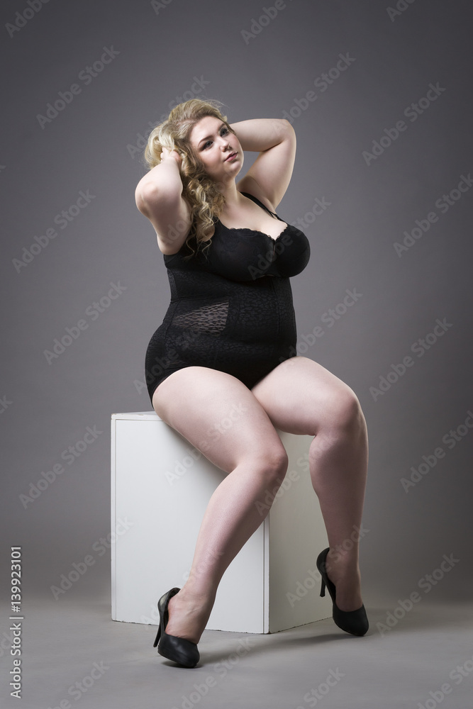 Young beautiful blonde plus size model in shapewear, xxl woman in slimming  underwear on gray studio background Stock Photo | Adobe Stock