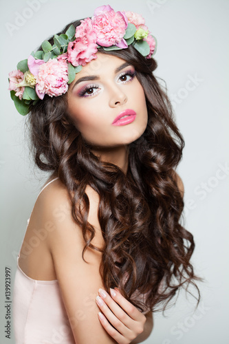 Beautiful Woman with Summer Pink Flowers. Brunette Beauty