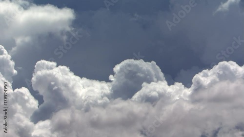 Cumulus billowing in blue sky, time lapse photo