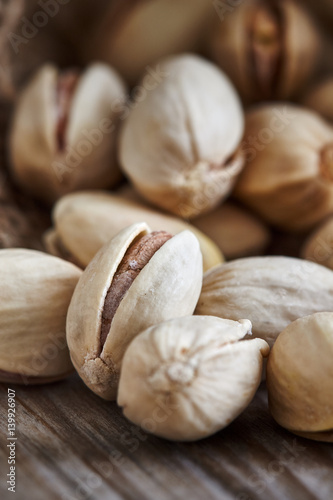 Pistachios on wooden background. Close-up with selective focus