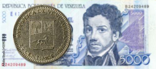 25 centimos coin against 5000 venezuelan bolivar bank note (blue) obverse photo