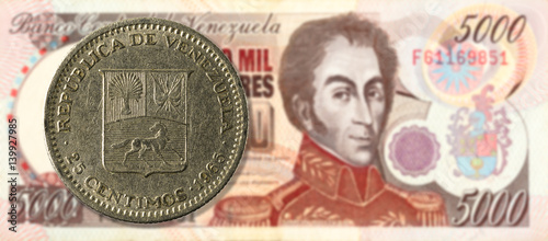 25 centimos coin against 5000 venezuelan bolivar bank note (brown) obverse photo