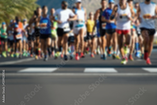 Marathon running race people feet on city road,abstract blurry