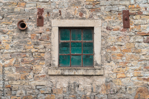 Old window on a stone wall