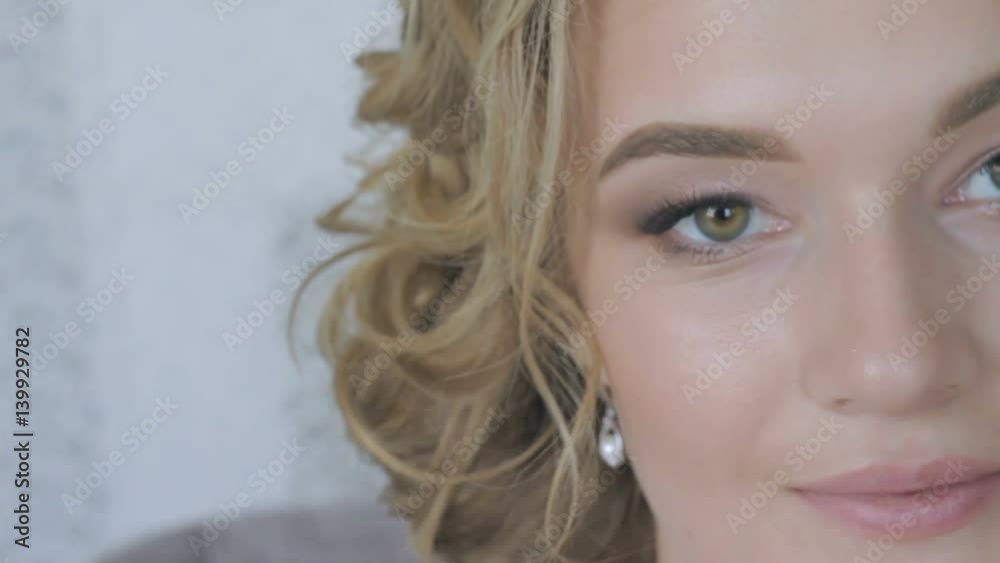 Beautiful woman in white is drinking coffee close-up Beautiful woman in white is drinking coffee close-up