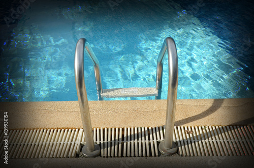 Swimming pool with stair at...