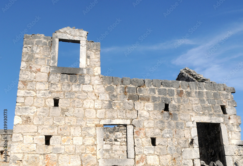 Traditional Mediterranean village, destroyed house, blue sky,