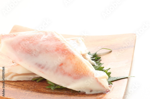 red fish frozen on wooden plate