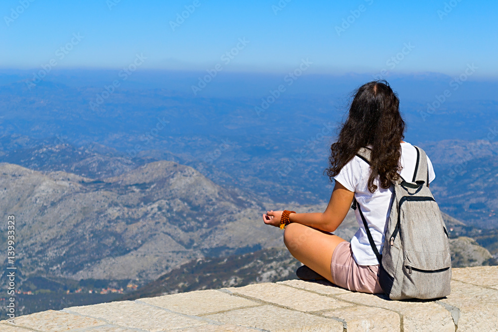 girl sitting on the Mount Lovcen in Montenegro 