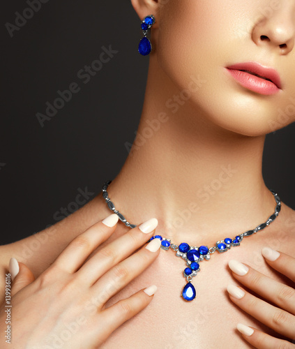 Beautiful woman with a sapphire necklace. Fashion concept