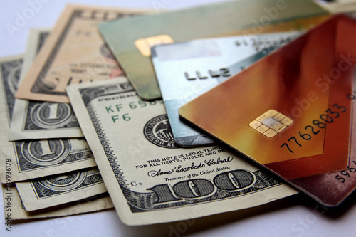 Stack of credit cards and american dollars, close-up view. Horizontal financial business background.