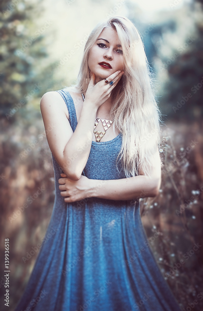 beautiful young woman in dress with long snow-white hair on nature beautiful young woman in dress with long snow-white hair on nature