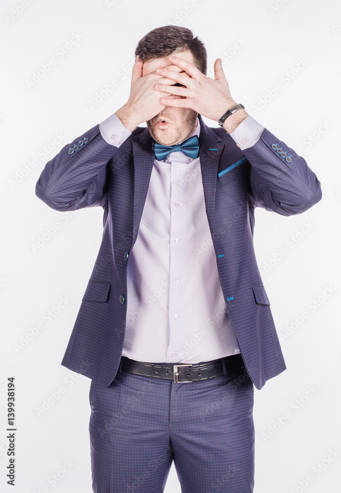 portrait young businessman covering his eyes with his hand. emotions, facial expressions, feelings, body language, signs. image on a white studio background. portrait young businessman covering his eyes with his hand. emotions, facial expressions, feelings, body language, signs. image on a white studio background.