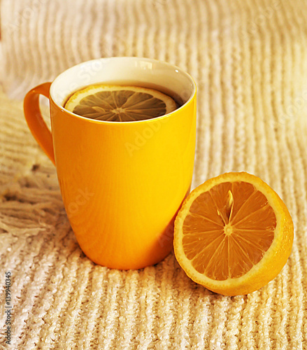 Yellow tea cup and lemon, hot drink