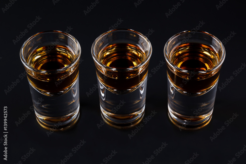 Three shots with cognac or jager on black Three shots with cognac or jager on black