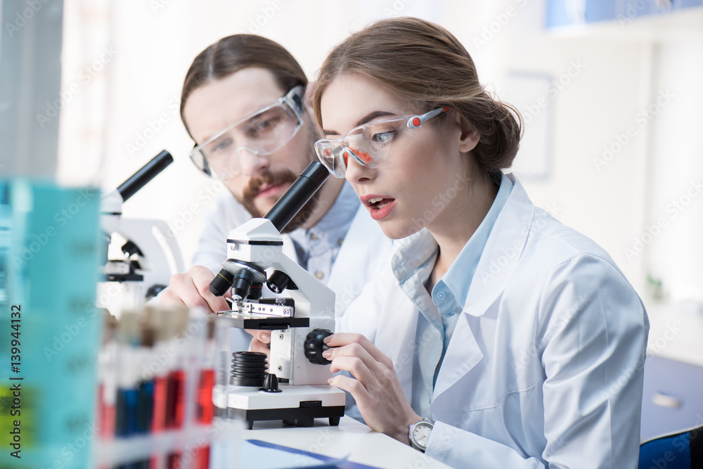 Chemists working with microscope Chemists working with microscope