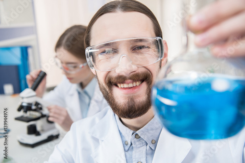 Scientist holding chemical reagent