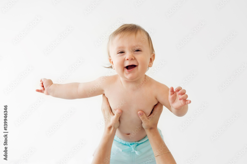 portrait of a smiling baby being hold in the air portrait of a smiling baby being hold in the air