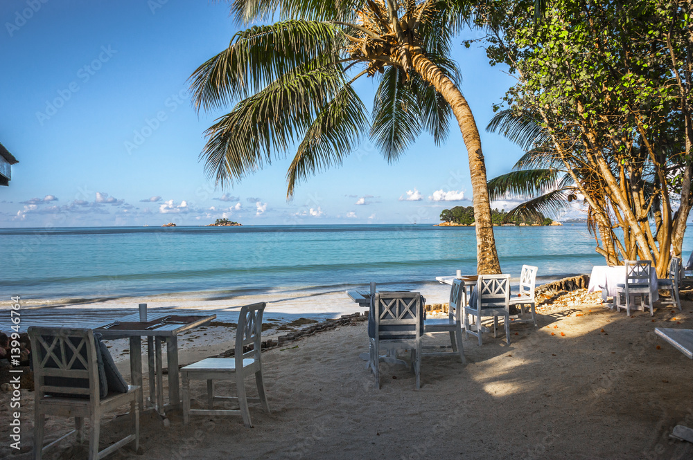 Beach of the Seychelles with table and chairs, Island Praslin, Beach Anse Volbert