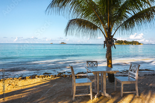 Beach of the Seychelles with table and chairs  Island Praslin  Beach Anse Volbert