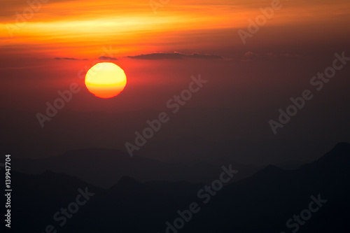 Sunset at the Mountain Hill,Beautiful sunlight, Golden lights background © 9kwan