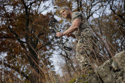 Bow hunter on a hill