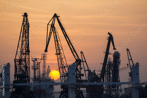Industrial port dockyard with sunset