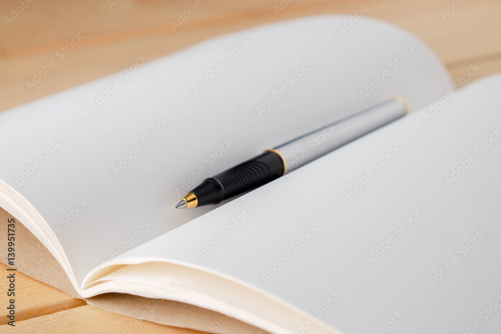 pen and book on wood background pen and book on wood background
