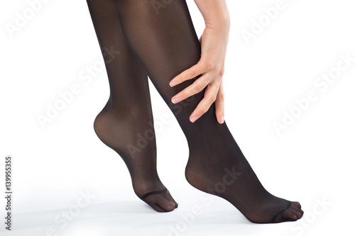 Woman's legs in tights wiht hand