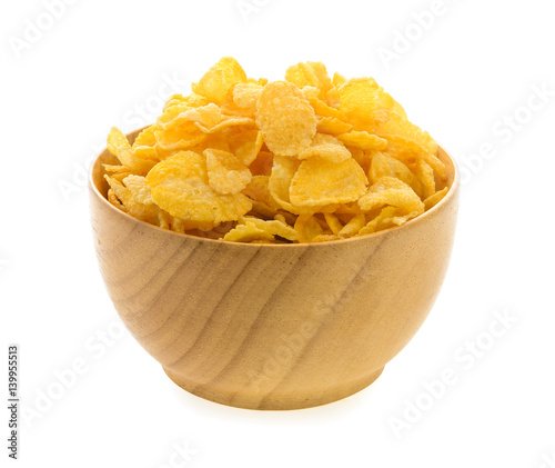 corn flakes in wood bowl isolated on white background