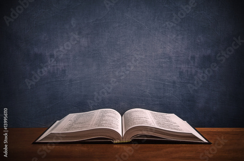 Fotografie, Obraz Open Bible on a wood desk