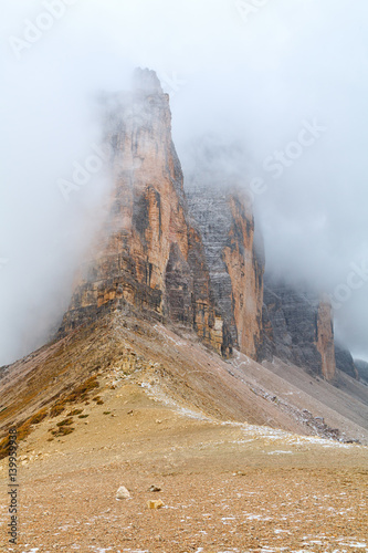 Tre Cime di Lavaredo in beautiful surroundings in the Dolomites at foggy weather (Drei Zinnen)