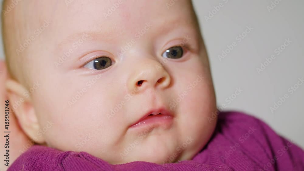 baby girl finger sucking mouth, development of the child, the Child lies on his mother's lap baby girl finger sucking mouth, development of the child, the Child lies on his mother's lap