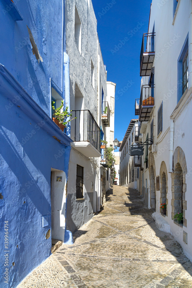 Street view of a small town on Mediterranean sea, Spain. Colorful and idyllic in summer.