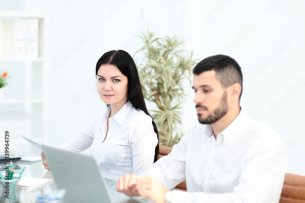 Image of business partners discussing documents and ideas at meeting Image of business partners discussing documents and ideas at meeting