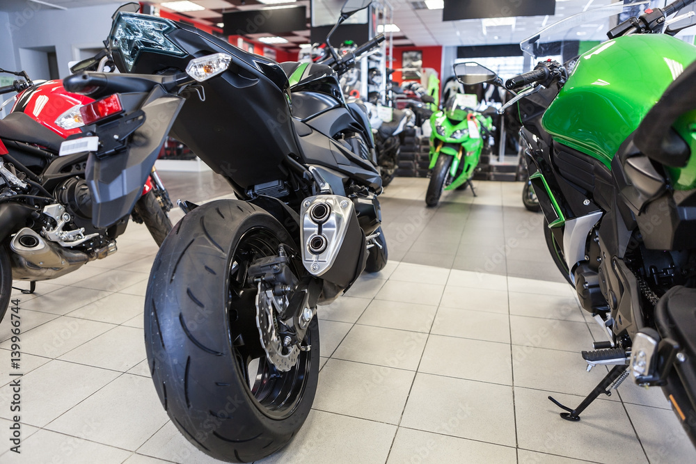Naked motorbikes standing in show room at sale. Motorcycle store