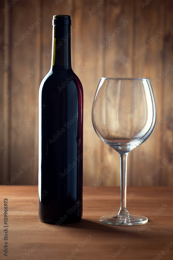 bottle of wine and a glass on old wooden table