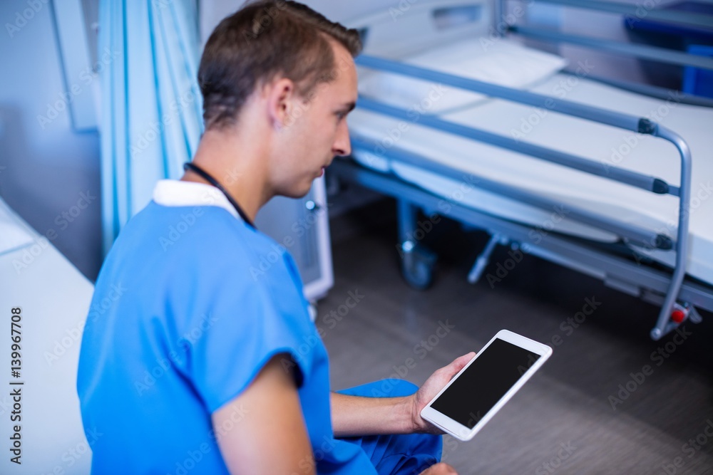 Doctor using digital tablet in ward Doctor using digital tablet in ward