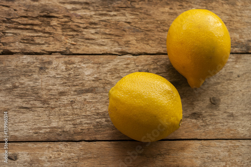 Lemon on old wooden background. Shallow depth of field, toned photo.