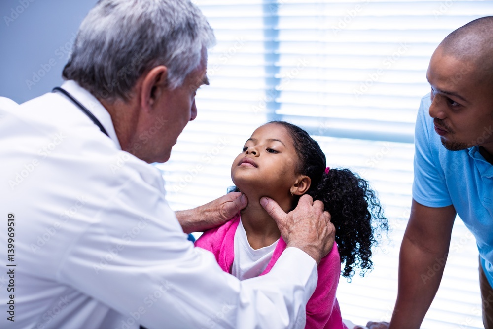 Fototapeta premium Doctor examining patients neck