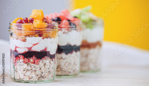 Oatmeal with fruit and cereals in a glass jar