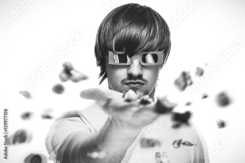 young man in stereo glasses throwing popcorn at the viewer 3d movie concept