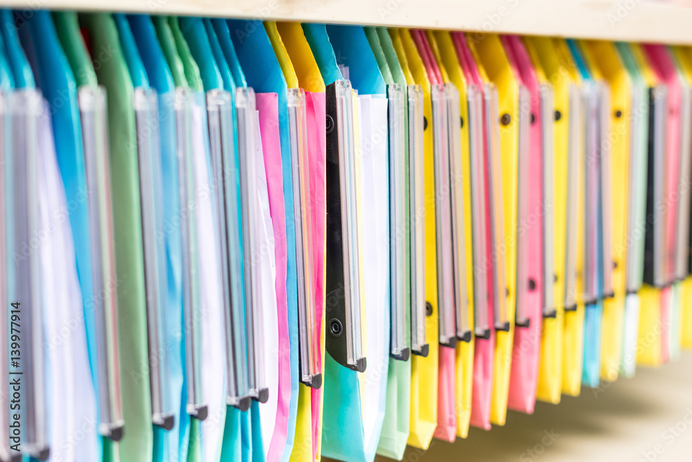 set of multi colored folders / files in metal enclosure / closet set of multi colored folders / files in metal enclosure / closet