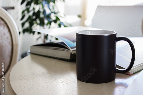Black mug, cup on a table, Mockup
