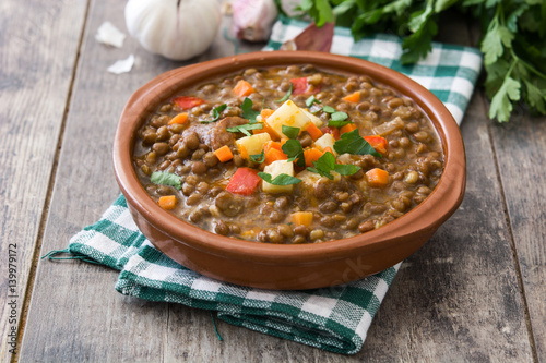 Lentil soup in a bowl on wooden background
 photo