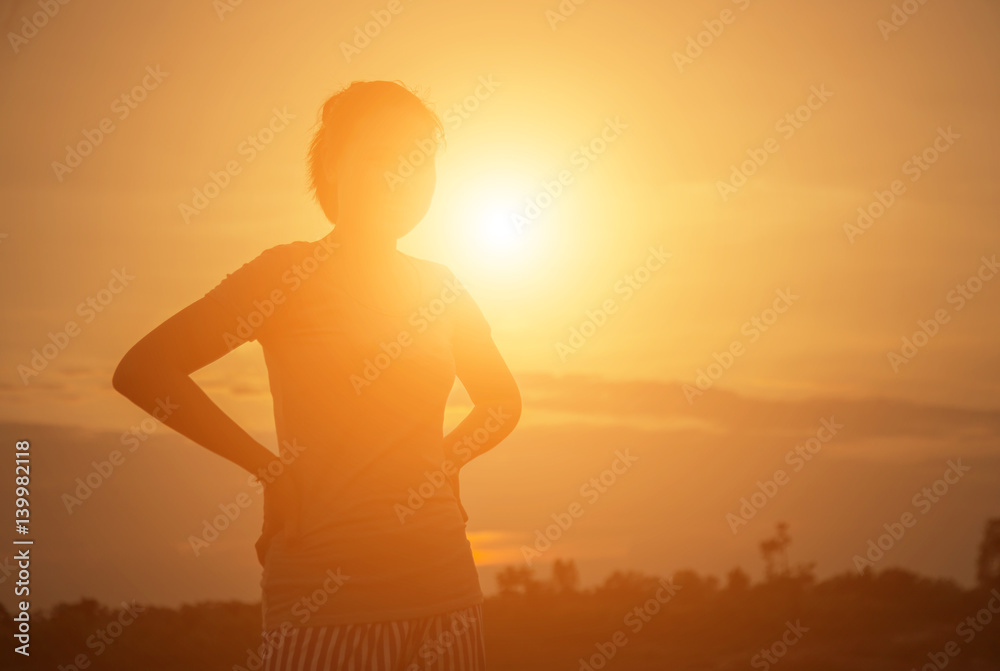 silhouette young woman at sunset