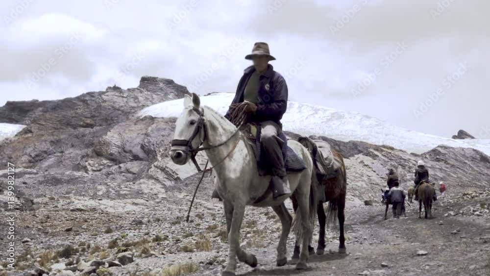 Muleteers riding mules on a countryside trail of the trekking Santa cruz, Peru Muleteers riding mules on a countryside trail of the trekking Santa cruz, Peru