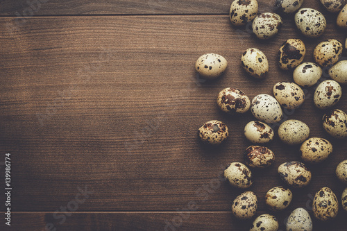 some quail eggs on the brown wooden table