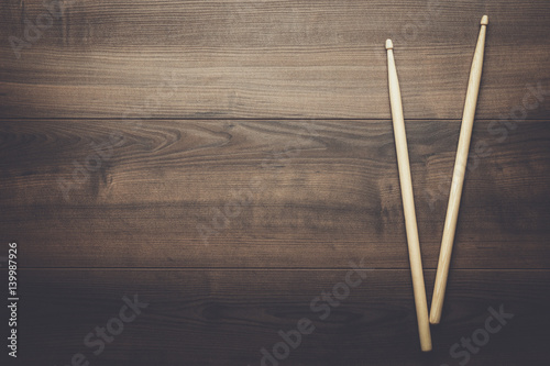 pair of wooden drumsticks on wooden table