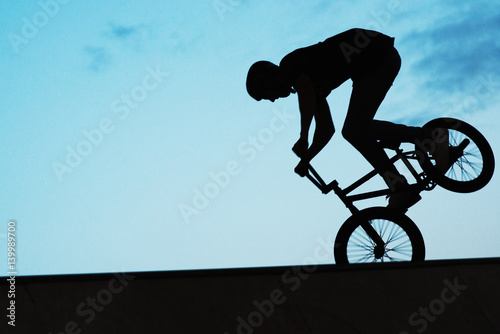 silhouette of a man on a bmx